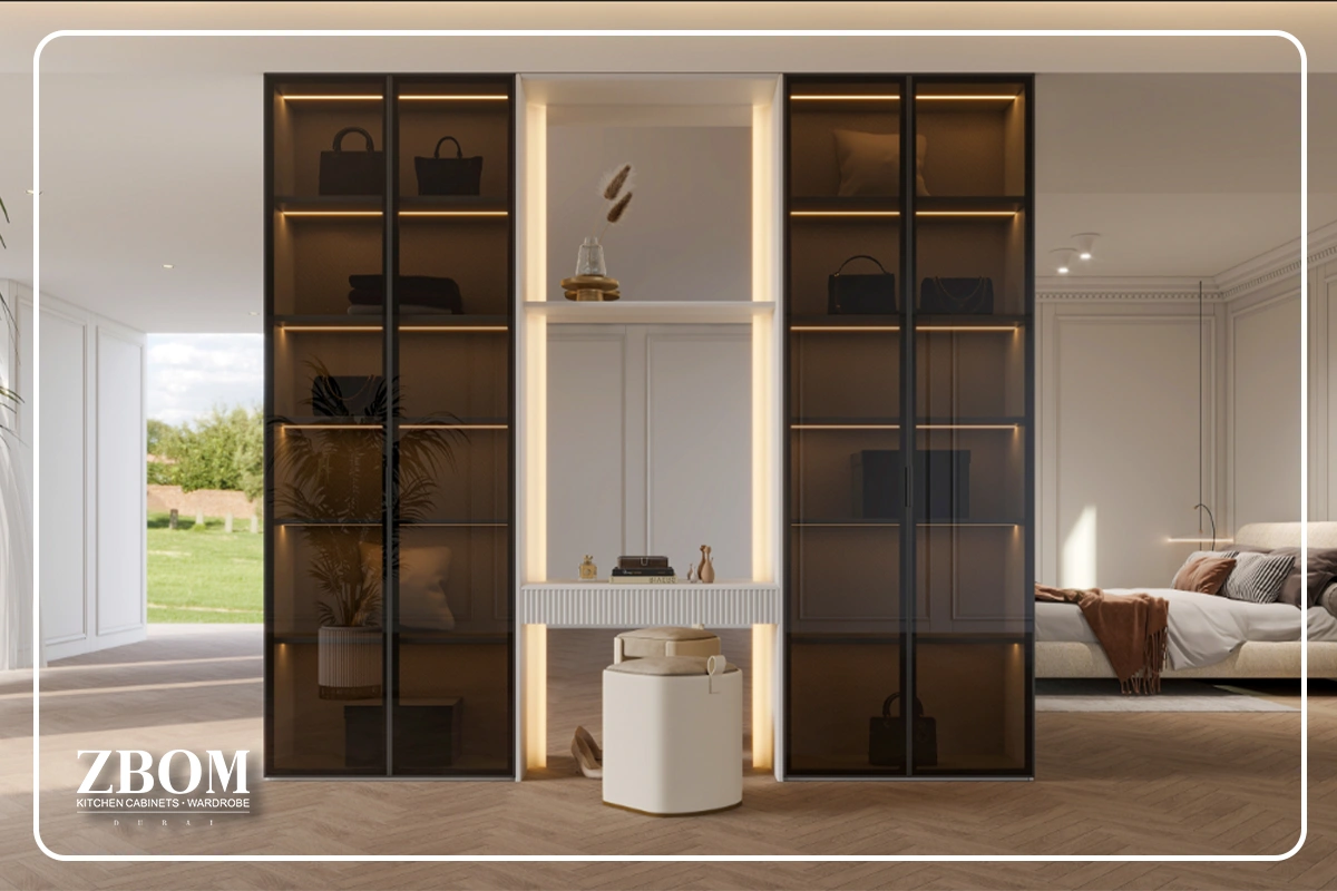 Modern built-in wardrobes with glass doors and warm LED lighting in a Dubai bedroom